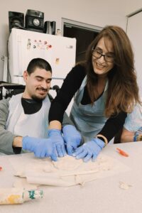 Participant Angel working with Clay, together with Instructor